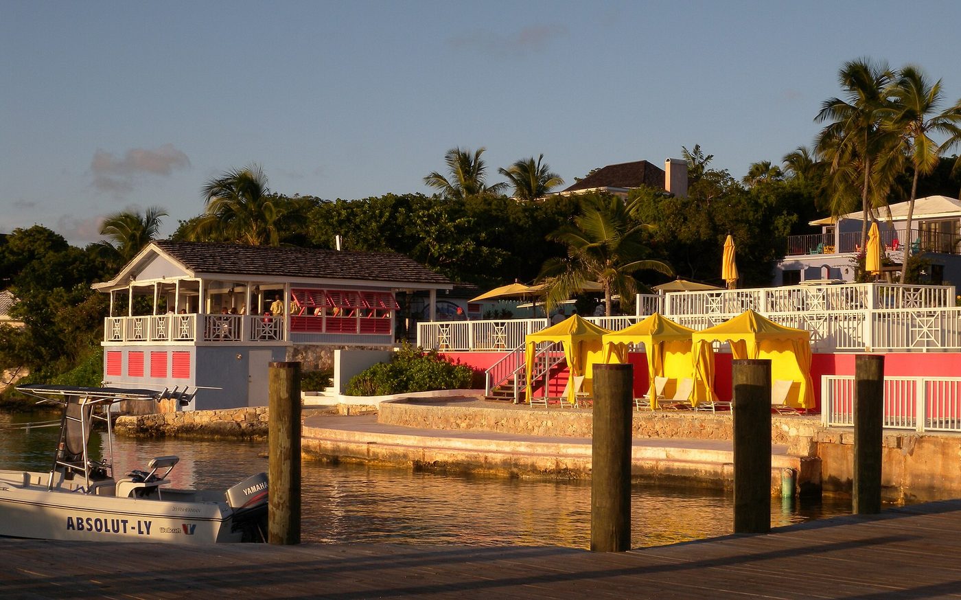 Painted waterfront buildings and a dock at Romara Bay, Harbour Island